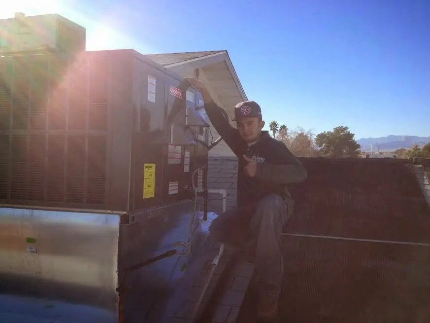 HVAC technician performing HVAC Inspection on a rooftop unit in Sturgeon Bay